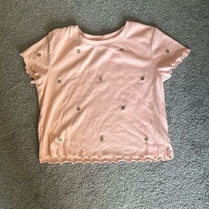 salmon pink shirt with happy faces on it